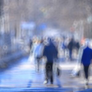 Abstract blurred image of people walking on a street, symbolizing blurred vision or visual distortion.