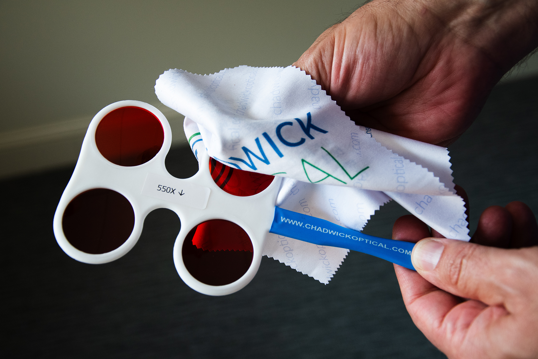 Showing how to clean the flipper lenses, with a clean optical cloth.