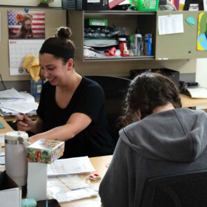 office-staff-4 Faith and Jordan collaborating at their workstation at Chadwick Optical.