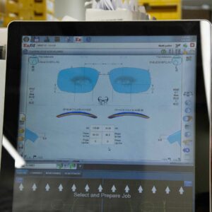 A screen displaying eyeglass lens design software, showcasing detailed measurements and parameters for custom lens creation.